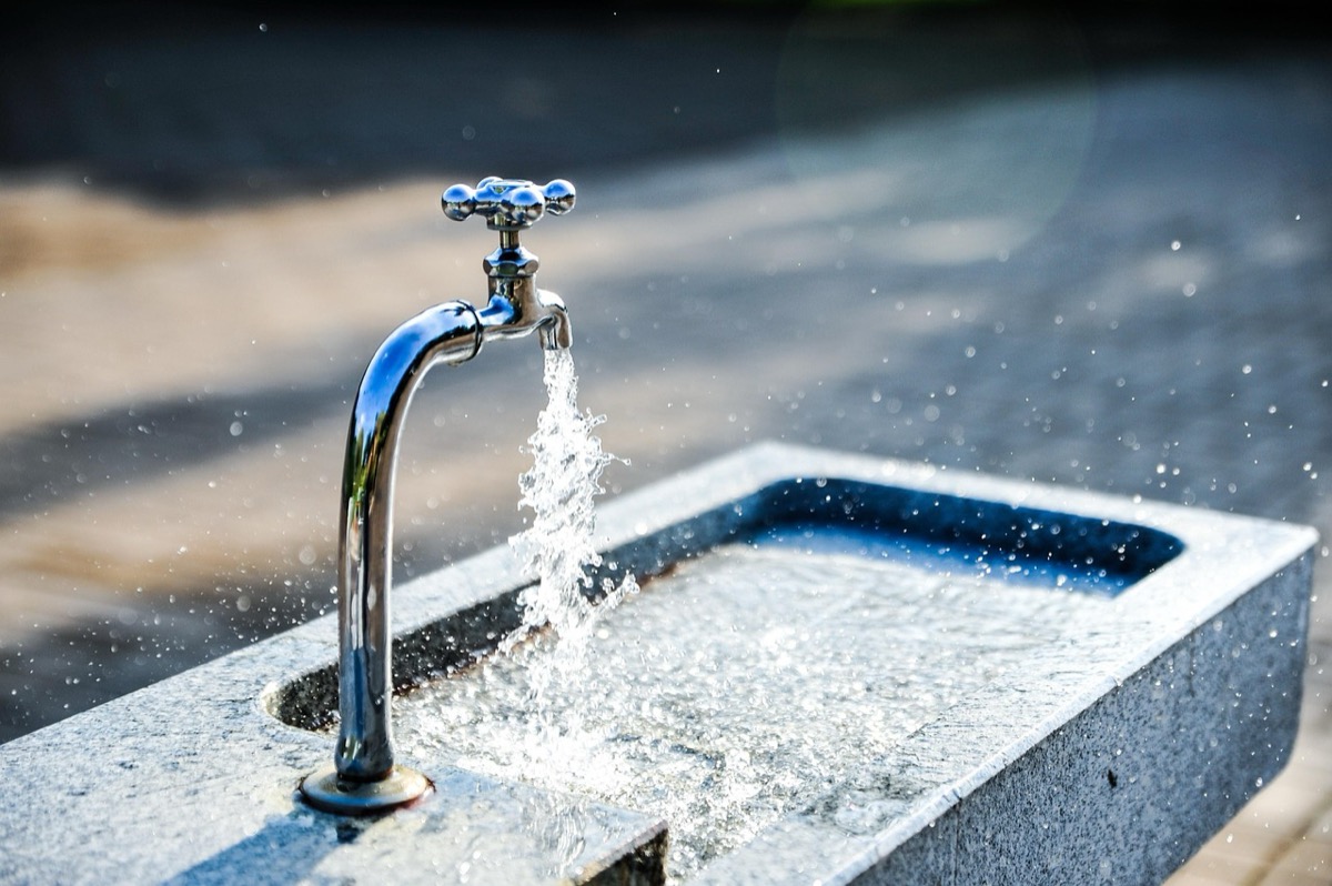 Clean filtered water flowing from kitchen faucet