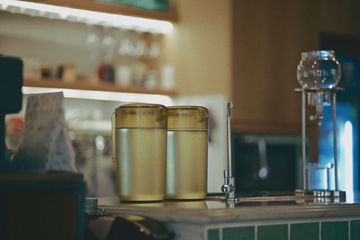 Water filter pitchers and dispenser on kitchen counter for clean drinking water