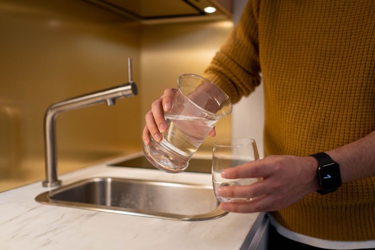 Interior of a fully stocked refrigerator with ice maker compartment visible