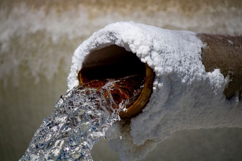 Pipe showing heavy mineral scale and rust buildup - hard water damage to plumbing
