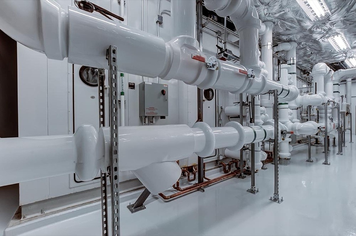 Modern residential plumbing pipes and filtration system in basement installation