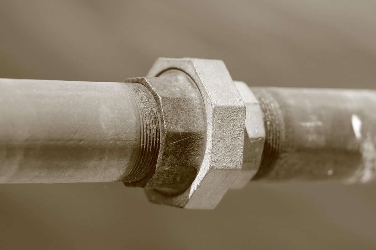 Close-up of galvanized pipe union fitting typical of water softener installation connections